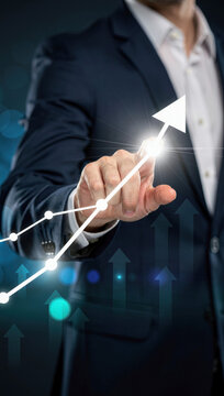 Businessman touching upward trending graph on digital interface showing business growth and success