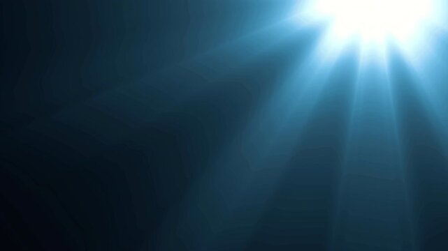 Abstract blue light rays emerging from corner on dark background.