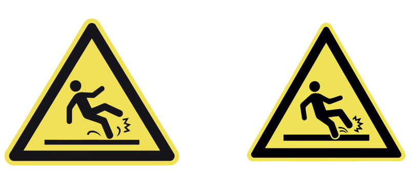 Yellow triangular caution signs indicating a wet floor and risk of slipping for safety.