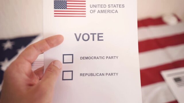 A U.S. citizen holding a ballot at a polling station during the U.S. Congressional midterm elections