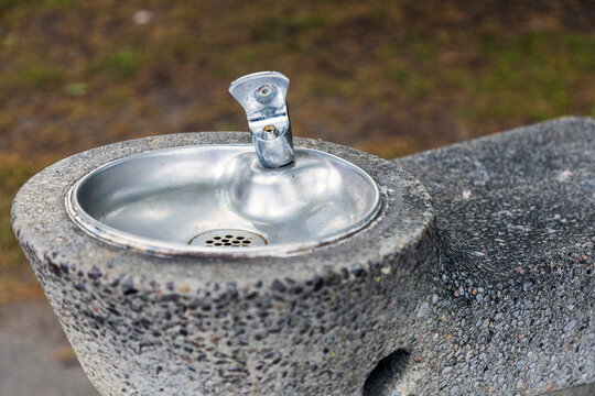 Close-up view of public drinking water fountain in urban park