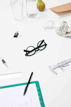 Modern workspace with tortoiseshell glasses, smartphone and tea