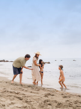 Happy family strolling at beach 