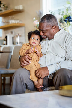 Grandfather Enjoys Time With Grandchild in Cafe Setting