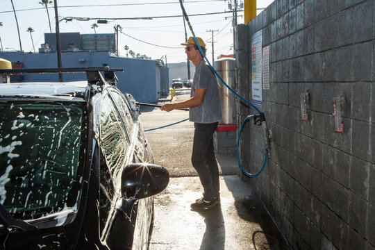 Man Washing Car on Sunny Day
