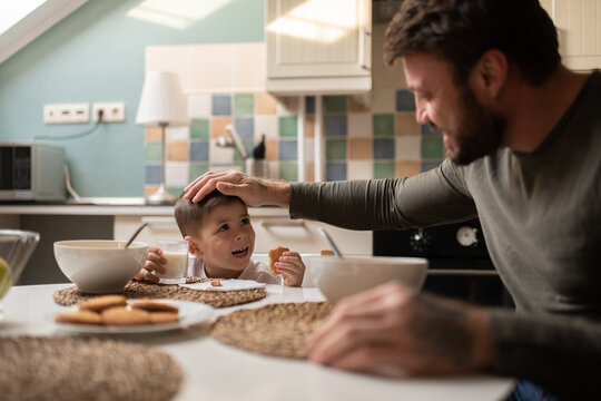 Father admiring son during breakfast