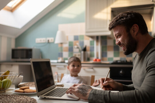 Happy freelancer working near son