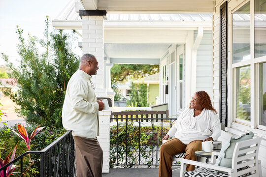 Couple Enjoys Conversation on Porch in Sunny Weather