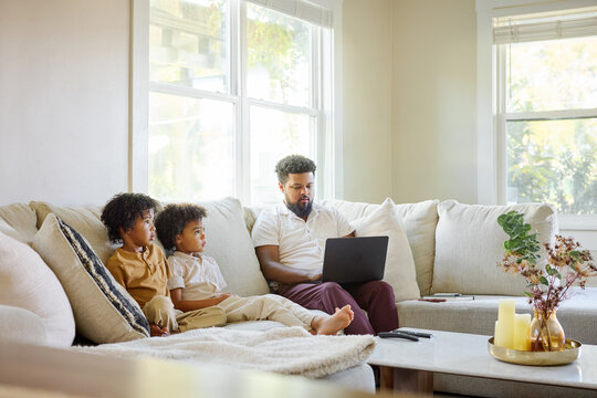 Father and Children Watch Video at Home Together