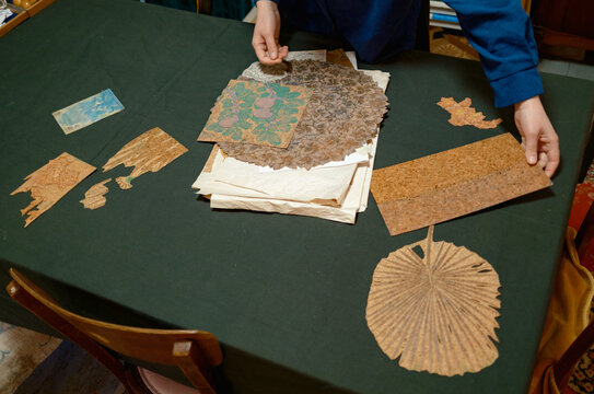 a female artist lays out her works on a table