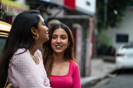 Two young Indian woman interacting at outdoors in daytime