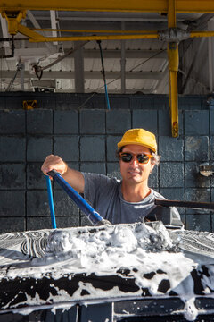 Man Washing Car on Sunny Day