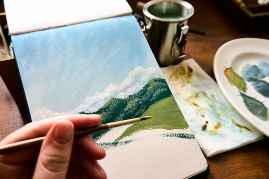 The artist with his paintbrush and behind him the other teacher
