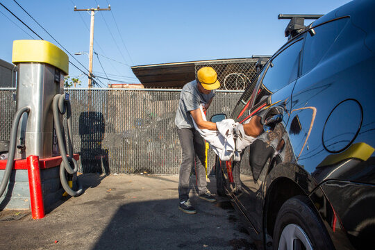Man Drying Off Car at Carwash