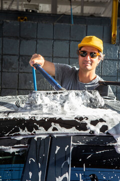 Man Washing Car on Sunny Day