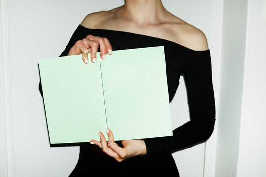 Person holding colourful mockup paper book with empty space for text