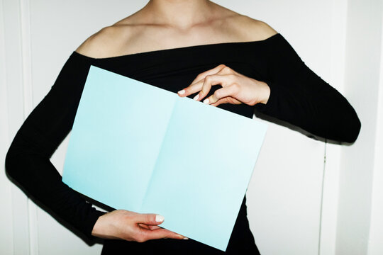 Person holding colourful mockup paper book with empty space for text