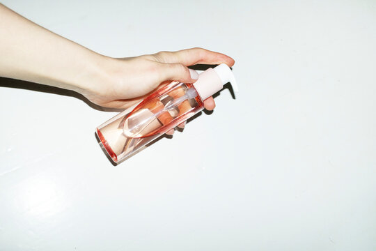 Pink beauty cosmetic product pump bottle with hard direct flashlight