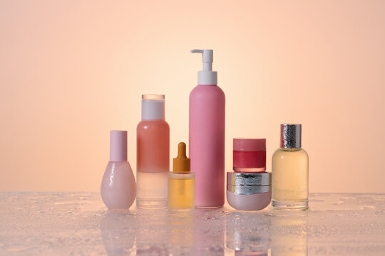 A stylish collection of skincare products artfully arranged on wet