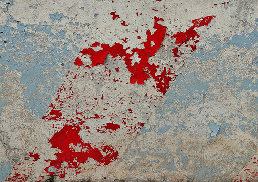 Parts of red paint on mangy vintage wall texture backdrop