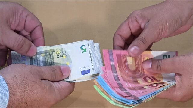 Euro money payment conclusion from woman to man, top view, financial concept