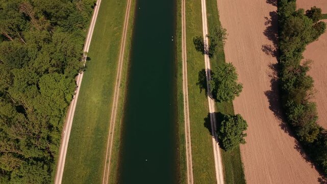 Sustainable power infrastructure on the river Iller captured via drone. A beautiful panoramic layout showcasing local public utilities, green technology and quiet countryside horizons.