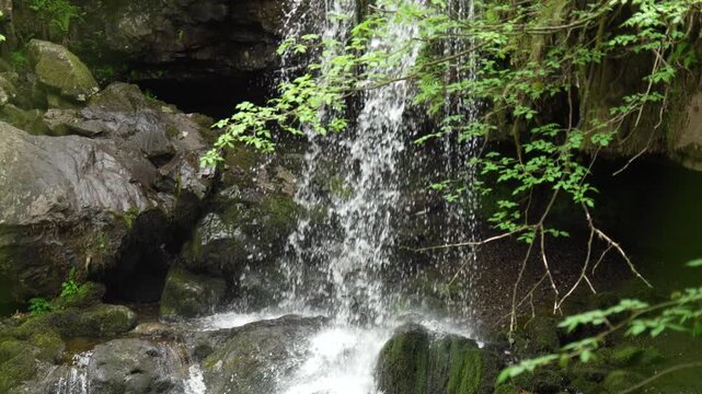 Water Splashing Over Rocks at the Base of a Waterfall