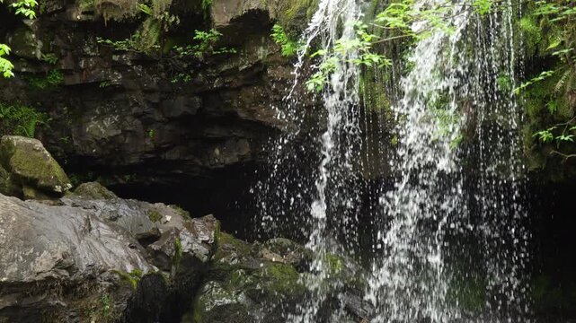 Waterfall Water Droplets Falling in Front of Dark Cave