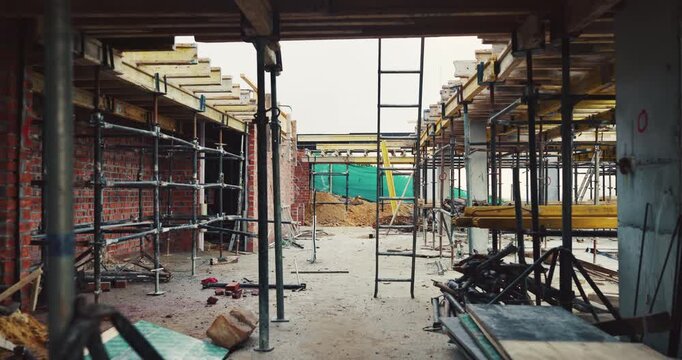 Construction, architecture or incomplete building at site for development, steel or engineering project. Brick wall, equipment or infrastructure, support structure or metal framework with ladder