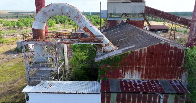 Industrial ruins of former phosphate mining plant in central Florida with old infrastructure and corroded metal structure.