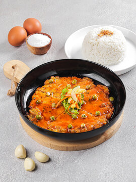 Spicy Tomato Egg Chicken Rice Bowl Served in Clay Pot with Steamed Rice