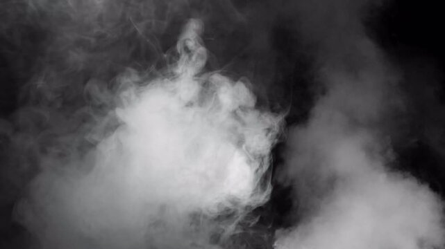 Abstract ethereal white smoke swirling against dark black background.