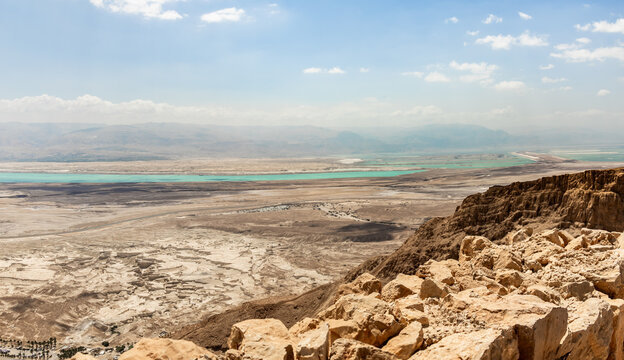 View  from walls of ruins of Masada fortress of adjacent plain and Dead Sea in southern Israel near the Arad