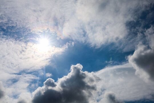 Sun shining through clouds with bright sky
