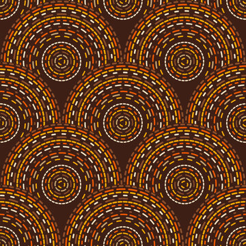 Seamless geometric vector pattern with concentric circular arches, dotted lines and tribal inspired motifs in brown, orange and gold tones.