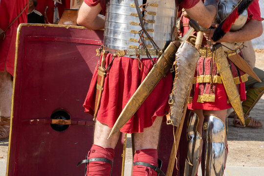 unrecognizable roman centurions with armor, shield and sword talking together
