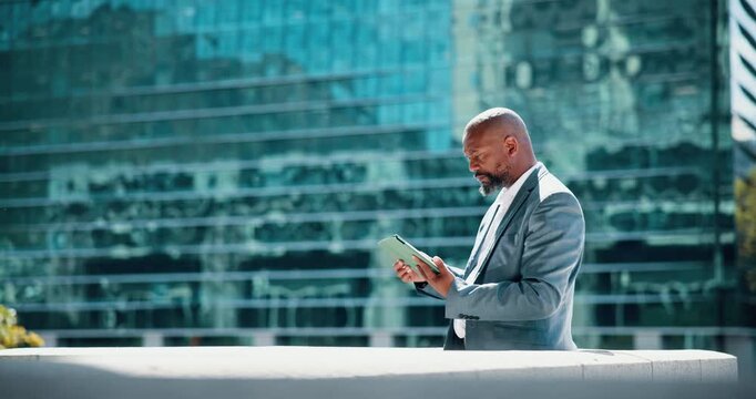 Business, man and online with tablet on balcony for market research, investment account and reading economy news. Mature trader, black person or browsing on digital app for crypto stock price outdoor