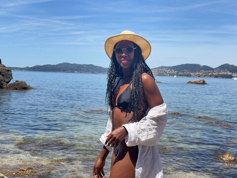 Woman enjoying summer day in clear waters at Samil Beach in Vigo Spain