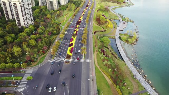 Aerial view of busy lakeside urban boulevard with traffic and waterfront park