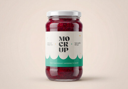 Front view of a clear glass jar mockup filled with red berry jam or raspberry preserves with a white metal lid and paper label isolated on a solid beige background