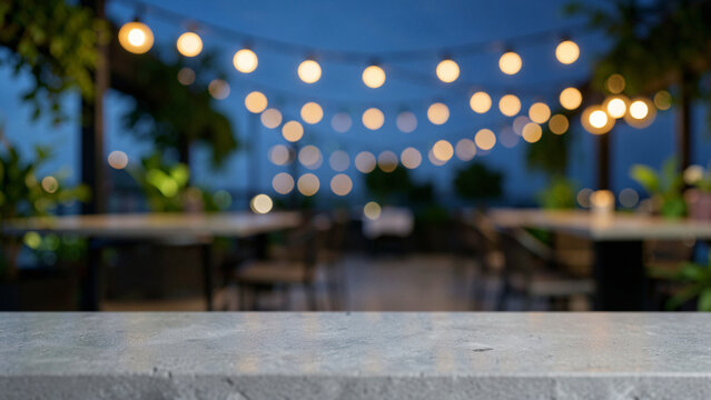 Honed Grey Concrete Table Surface on High End Botanical Rooftop Bar with Green Foliage Blur Luxury C