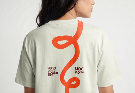 Back view of a woman wearing an oversized white cotton t-shirt mockup isolated on a solid light grey background