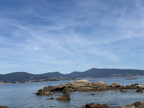 Rock formations in clear coastal waters at Samil Beach in Vigo Galicia Spain