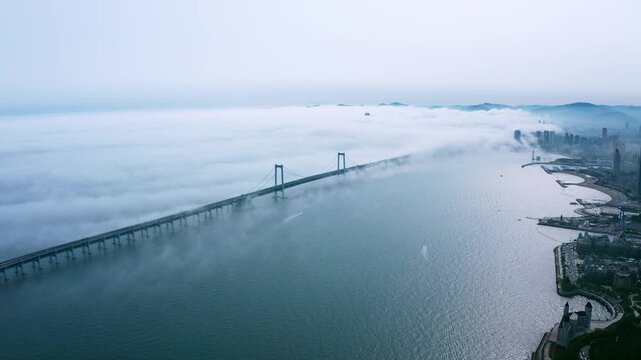 Xinghai Bay Bridge in Dalian China Covered by Morning Fog
