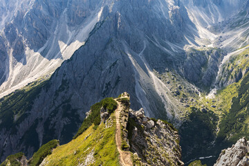 Fototapeta premium South Tyrol, Italy - August 30. 2024: The steep path to the famous viewpoint of Cadini di Misurina mountain range in the Tre Cime region, Dolomites, Italy