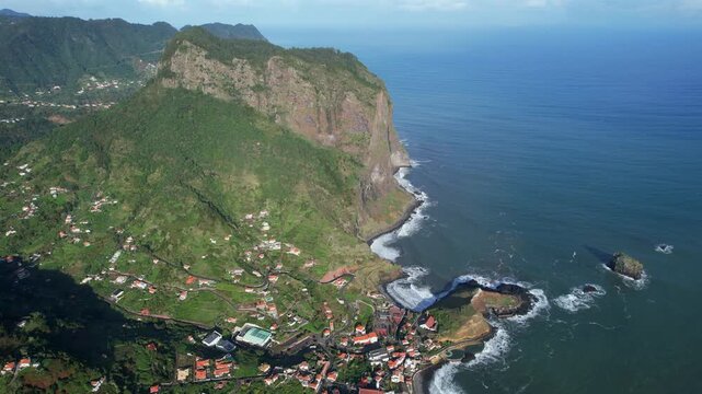 Scenic aerial view of Porto da Cruz town and Penha da Aguia rock formation on the coast of Madeira island, Portugal