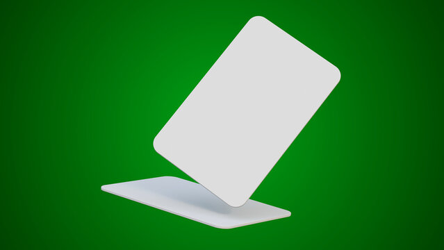 Two blank white plastic cards are displayed isolated on a green background. This mockup template is ideal for showcasing corporate identity or credit card designs.