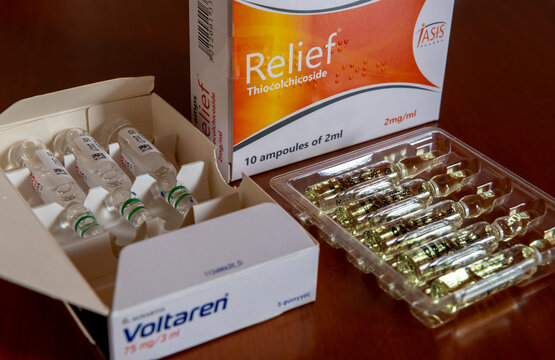 Lefkada, Greece- May 30. 2026. The packages and contents of Voltaren and Relief thiocolchicoside injection solutions, prescribed together by doctor for back pain treatment.