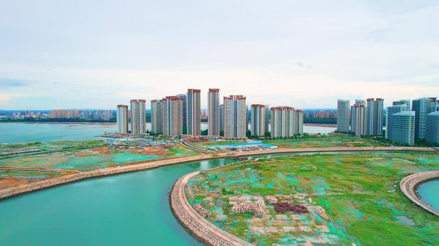 Aerial view of modern waterfront residential towers by a calm coastal bay