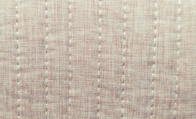 Naklejka premium close up of beige melange quilted fabric with vertical stitching